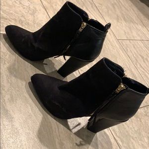 Black booties with double gold zippers